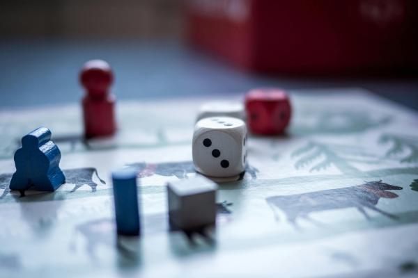 close up shot of a board game with pieces and a die